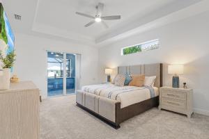 a bedroom with a bed and a ceiling fan at BIG WATER VIEW!, Heated Saltwater Pool and Spa - Villa Manatees Crossing - Roelens in Matlacha