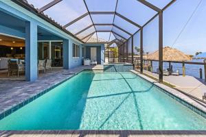 a swimming pool in a villa with a view of the ocean at BIG WATER VIEW!, Heated Saltwater Pool and Spa - Villa Manatees Crossing - Roelens in Matlacha