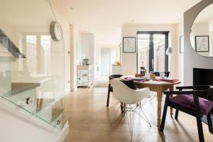 a dining room and living room with a table and chairs at White Cottage in Whitstable