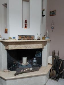 a living room with a stone fireplace with a candle at House by the sea/Σπίτι στην θάλασσα in Flámbouras