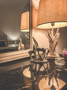 a table with a lamp and a horse statue on it at Flat 291 in Polignano a Mare