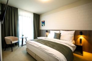 Postel nebo postele na pokoji v ubytování Hotel Rajka