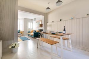 a kitchen with a table with a bottle of wine at Fig Tree Cottage in Whitstable