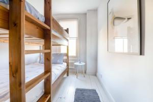 a bedroom with two bunk beds in a room at Fig Tree Cottage in Whitstable