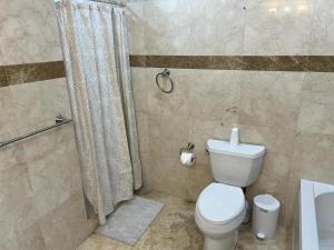 a bathroom with a toilet and a shower at Cozy lakeside suite with private bath & entrance in Pembroke Pines