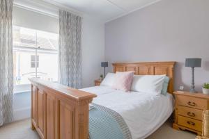 a bedroom with a bed and a window at Furlong Place in Whitstable