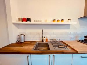 a kitchen with a sink and a counter top at Seal Cottage in Whitstable