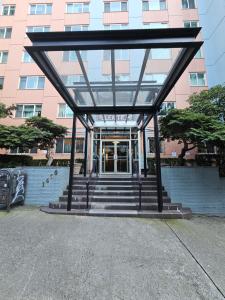 a glass building with stairs in front of a building at Cozy 1BR with Free Parking Downtown Conv Center in Seattle