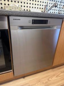 a stainless steel dishwasher in a kitchen at MELLoWY Monteure, TV, Küche, Bad in Gaggenau