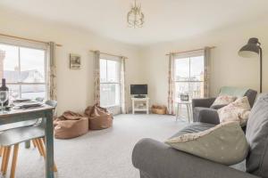 a living room with a couch and a table at Rooftops in Whitstable