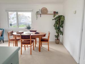 a dining room with a table and chairs at Peaceful Riverside Lodge in Christchurch