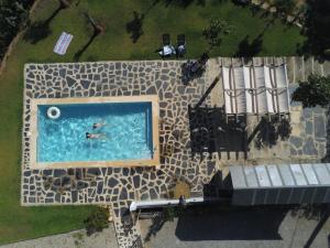 an overhead view of a person swimming in a swimming pool at Abrigo das Andorinhas in Sameiro