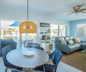 a living room with a table and a couch at Waterfront with Boat Lift/Kayaks and Hot Tub in Marathon