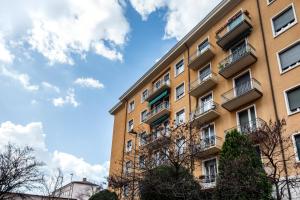 a yellow building with balconies on the side of it at Deluxe Home Verona in Verona