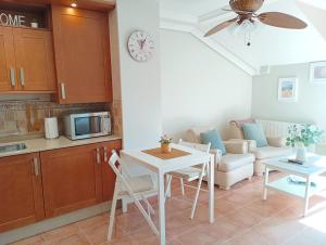 a kitchen and living room with a table and a couch at Combarro Hills in Combarro