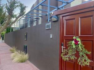 a red door with a wreath on it next to a building at EZE Inn Boutique Hotel in Ezeiza