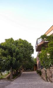 an empty street next to a building with a tree at OldByurakan Villa in Byurakan