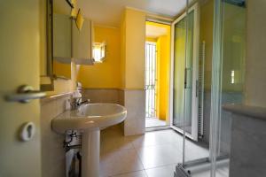 a bathroom with a sink and a glass shower at Montebello Lake in Lecco