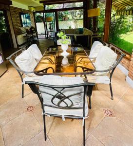 a glass table and chairs on a patio at Descanso Urbano in Santiago