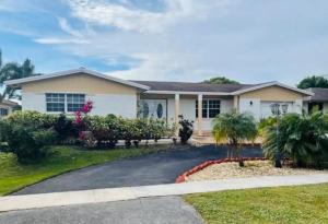 a house with a driveway in front of it at Cozy lakeside suite with private bath & entrance in Pembroke Pines