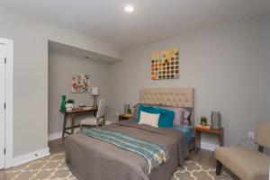 a bedroom with a large bed and a chair at PRISTINE 3 bdrm - Garage Parking - Close to UPENN in Philadelphia
