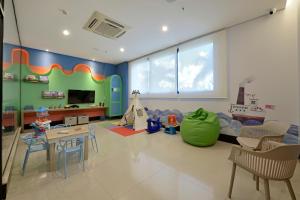 a childrens room with a play area with a table and chairs at Hotel Mont Blanc Premium in Ribeirão Preto