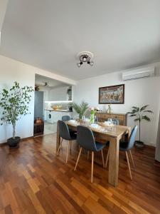 a dining room with a wooden table and chairs at Kakavanen’s Sea View apartment in Balchik