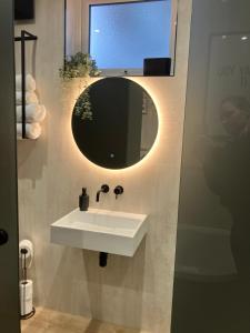 a bathroom with a white sink and a mirror at Abbey Court Guest House in Carlisle