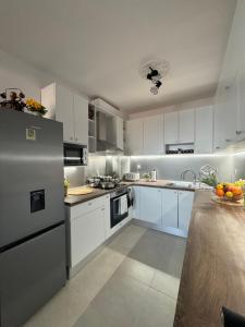 a kitchen with white appliances and a counter top at Kakavanen’s Sea View apartment in Balchik