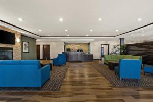 a lobby with blue couches and a waiting room at Comfort Inn & Suites Newcastle - Oklahoma City in Newcastle