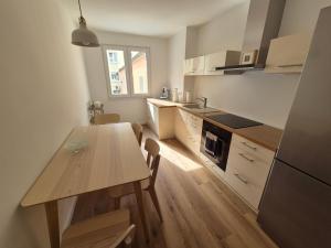 a kitchen with a wooden table and a dining room at Aus alt wird neu - Apartment in Essener City in Essen