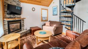 a living room with a couch and a fireplace at Muskoka Lakefront 3-bdrm Chalet in Port Carling