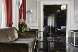 a living room with a couch and a table at The Queens Gate Hotel in London