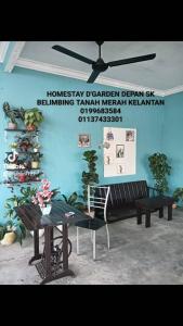 a room with two benches and a ceiling fan at D GARDEN HOME STAY in Tanah Merah