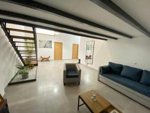 a living room with a blue couch and a chair at CASUAL LOFT-HOUSE in Agüimes