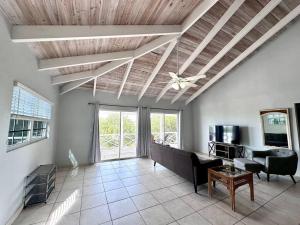 a living room with a ceiling fan and a couch at Entire Waterfront House in Turtle Cove