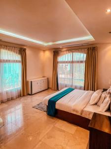 a bedroom with a large bed and two windows at Private Room Villa Dubai in Dubai