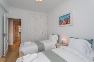 two beds in a room with white walls at BeGuest Retiro da Guia in Cascais