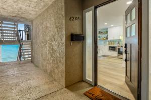 an open door to a kitchen with a view of the ocean at Del Mar Gem condo in Solana Beach
