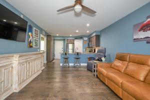 a living room with a couch and a bar at Harbour House at the Inn 212 in Fort Myers Beach