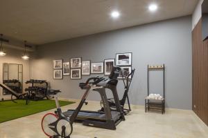 a gym with exercise bikes and pictures on the wall at Hotel Antik San Sebastián in Donostia-San Sebastián