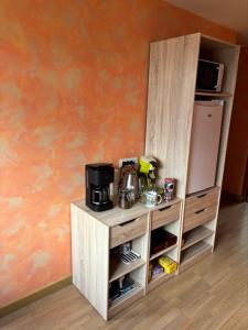 een kast met een koffiezetapparaat en een koelkast bij Nid de Pie in Crozon +22 foto's