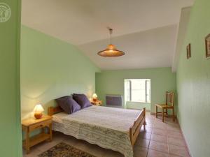 a bedroom with a large bed in a room at Gîte Saint-Alban-les-Eaux, 3 pièces, 4 personnes - FR-1-496-75 in Saint-Alban-les-Eaux