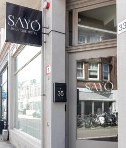 a sign for aoya boutique hotel on the side of a building at SAYŌ Boutique Hotel in Scheveningen