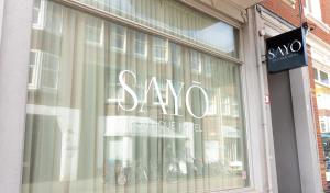 a store window with a sale sign on it at SAYŌ Boutique Hotel in Scheveningen