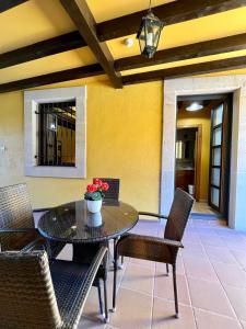 a patio with a table and chairs with flowers on it at Apartamentos Turisticos Paseo de la Alameda in Villaviciosa