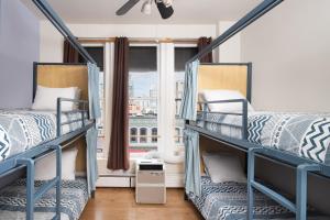 two bunk beds in a room with a window at HI San Diego Downtown Hostel in San Diego