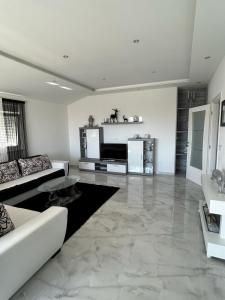 a living room with a marble floor and a couch at MAK apartment in Kaštela