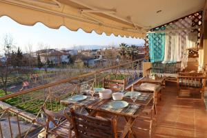 a balcony with a table and chairs and a view at The Seashell apartment in Keramoti