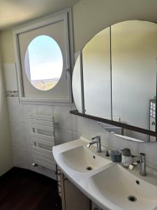 uma casa de banho com um lavatório e um espelho em Nid de Pie em Crozon